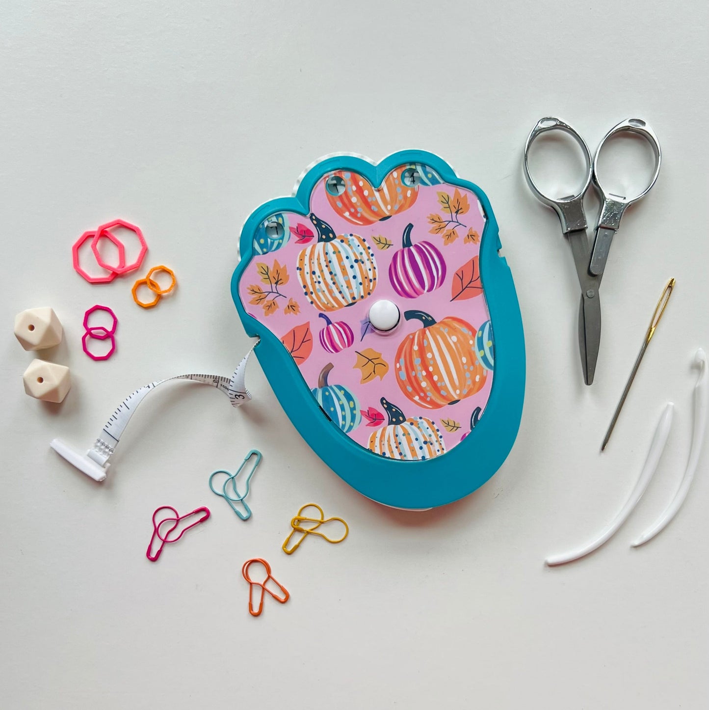 Decorative knitting kit with colorful pumpkins on a light gray background