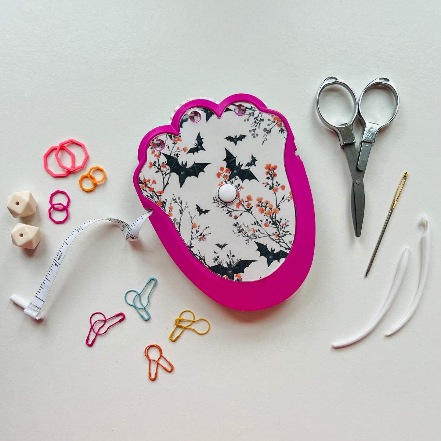 Pink knitting kit with floral design on a white background