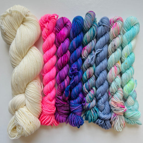 Set of colorful yarn skeins on a white background