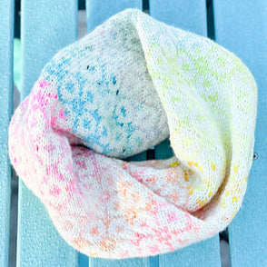 Colorful infinity scarf on a light blue chair outdoors