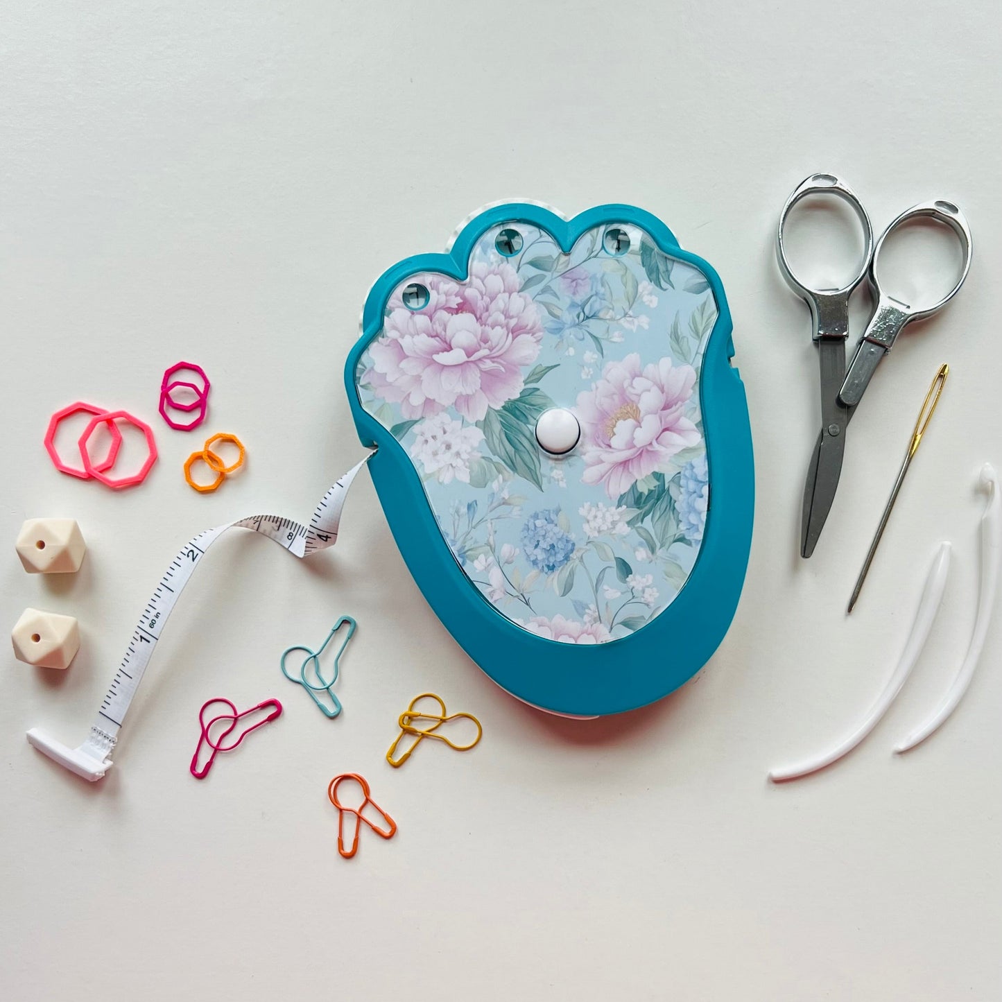 Decorative knitting kit with floral design on a white background