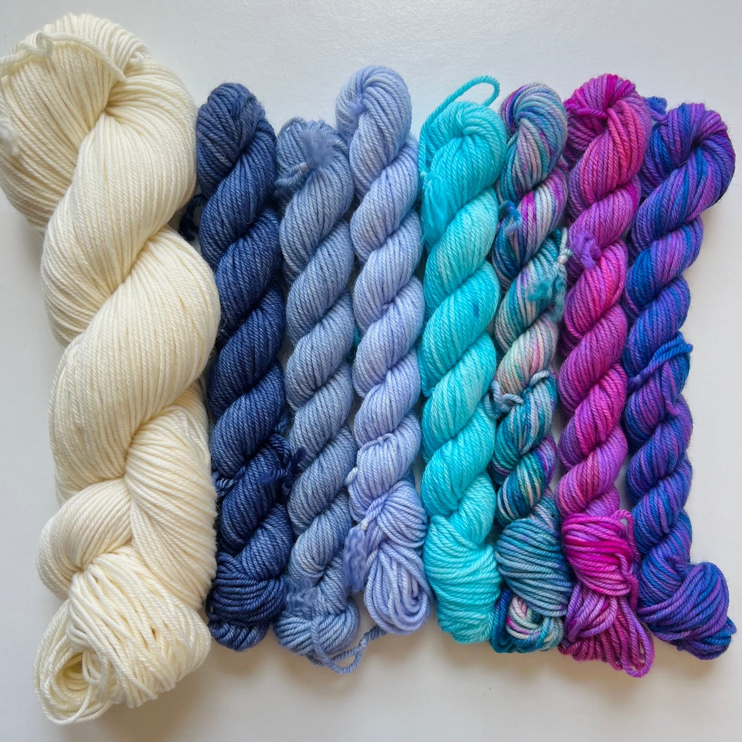 Set of yarn skeins in various colors on a white background