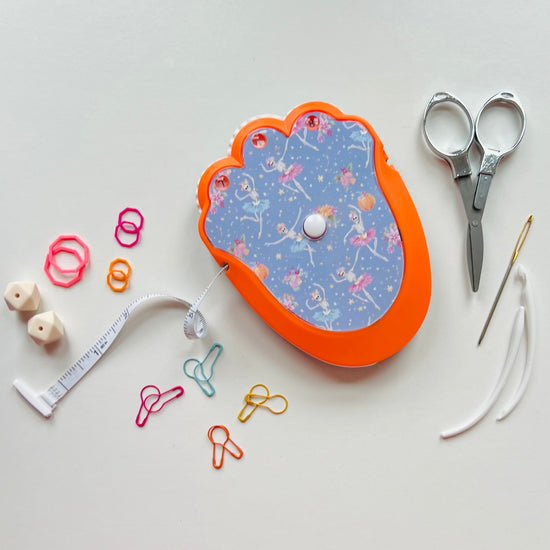 Decorative knitting kit with scissors, measuring tape  on a light gray background