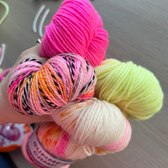 view of summer camp yarn in pink, yellow, white pink multi, and orange pink multi